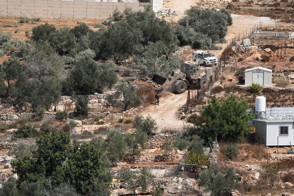 Israeli military machinery uproots olive trees in the Palestinian village of Beit Rima near Ramallah, in the Israeli-occupied West Bank, September 24, 2026. (Reuters)