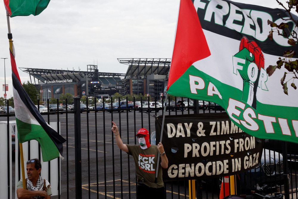 Pro-Palestinian protesters demonstrate near the venue of pop star Ed Sheeran's concert on 19 September after rapper Macklemore was cut from the musical lineup over his 
