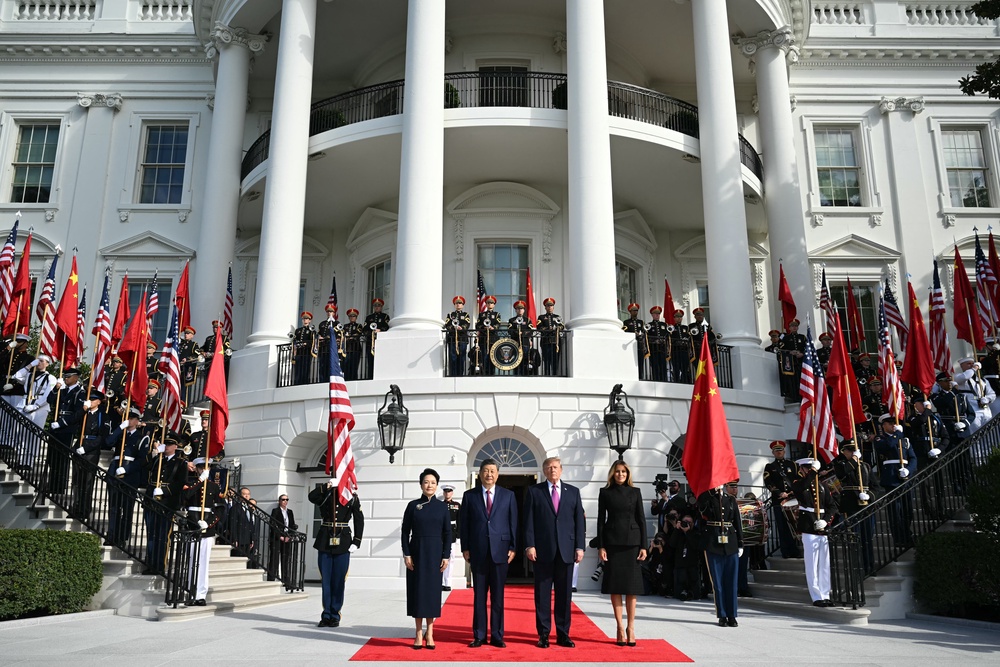 Trump and Xi pose for photos with their spouses Melania Trump and Peng Liyuan outside of the White House (AFP/Getty)