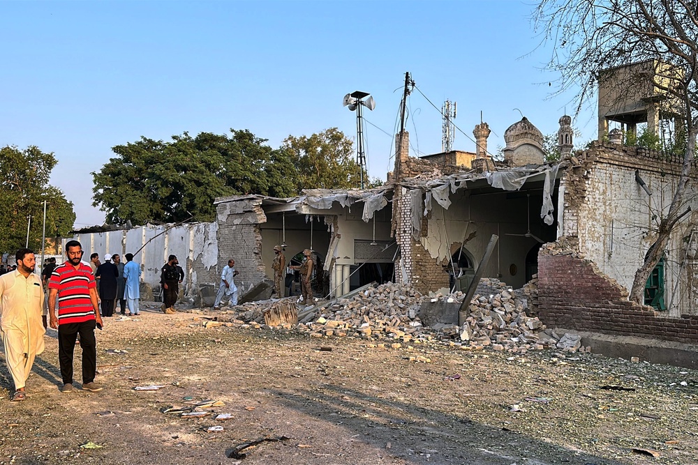 Army soldiers and local residents gather at the site of a powerful bomb explosion at a mosque in Kohat, in northwestern Pakistan, Friday, 18 September 2026 (AP)
