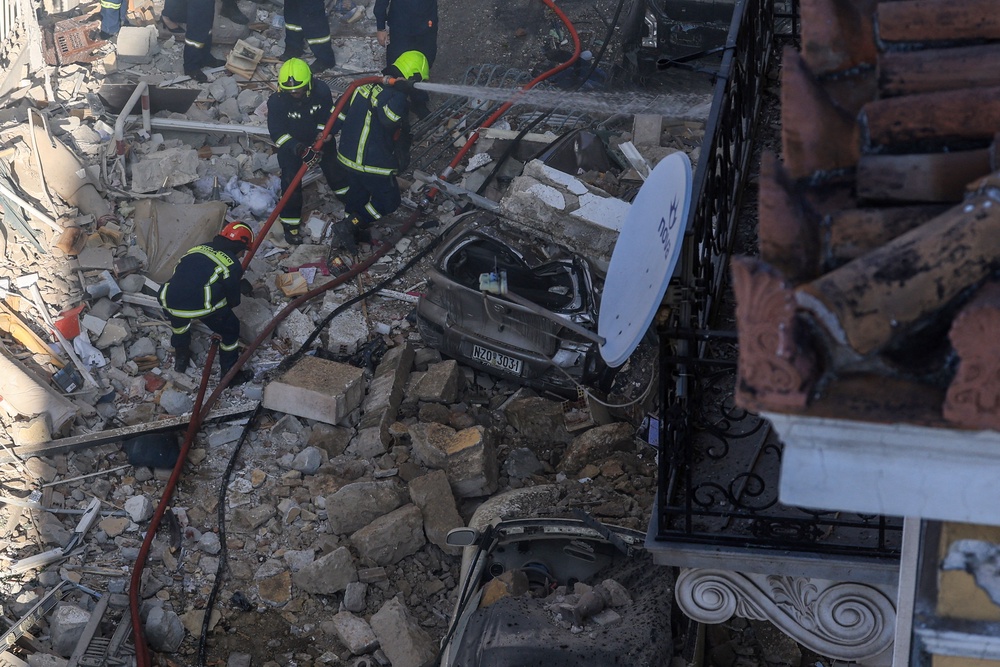 Emergency personnel work at the site where an old building partially collapsed in Athens on Friday (Reuters)