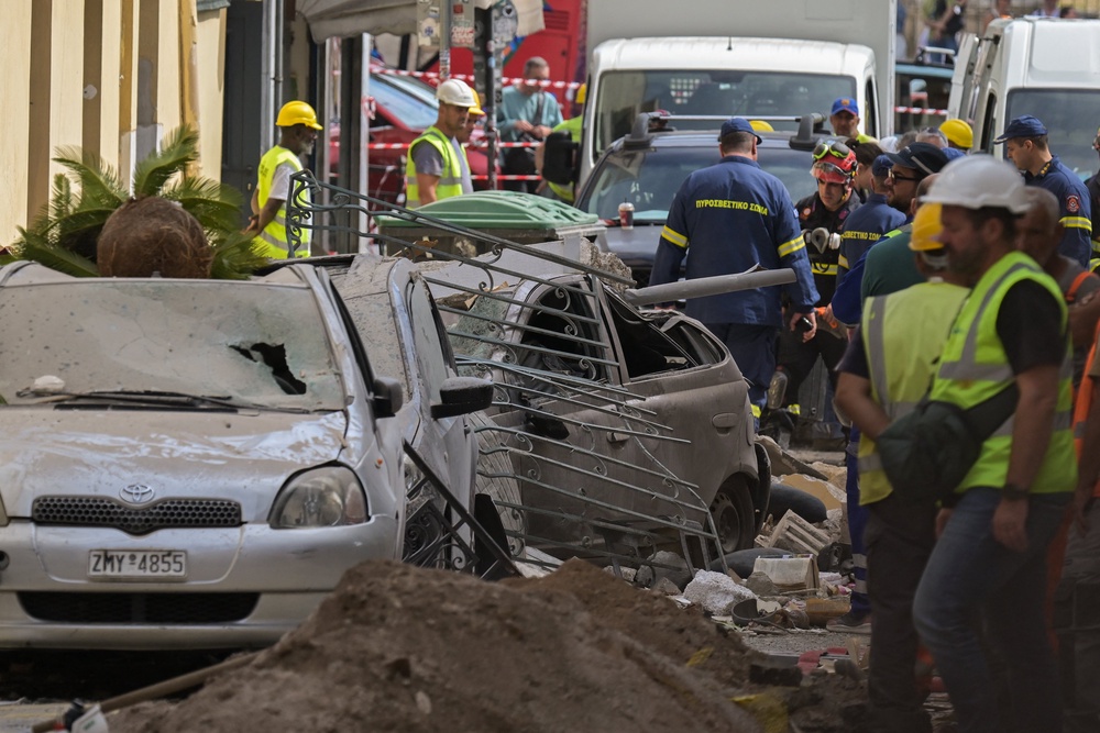 Emergency personnel operate at the site of an old building that partially collapsed following an explosion in the Plaka area of central Athens on September 25, 2026 (AFP/Getty)