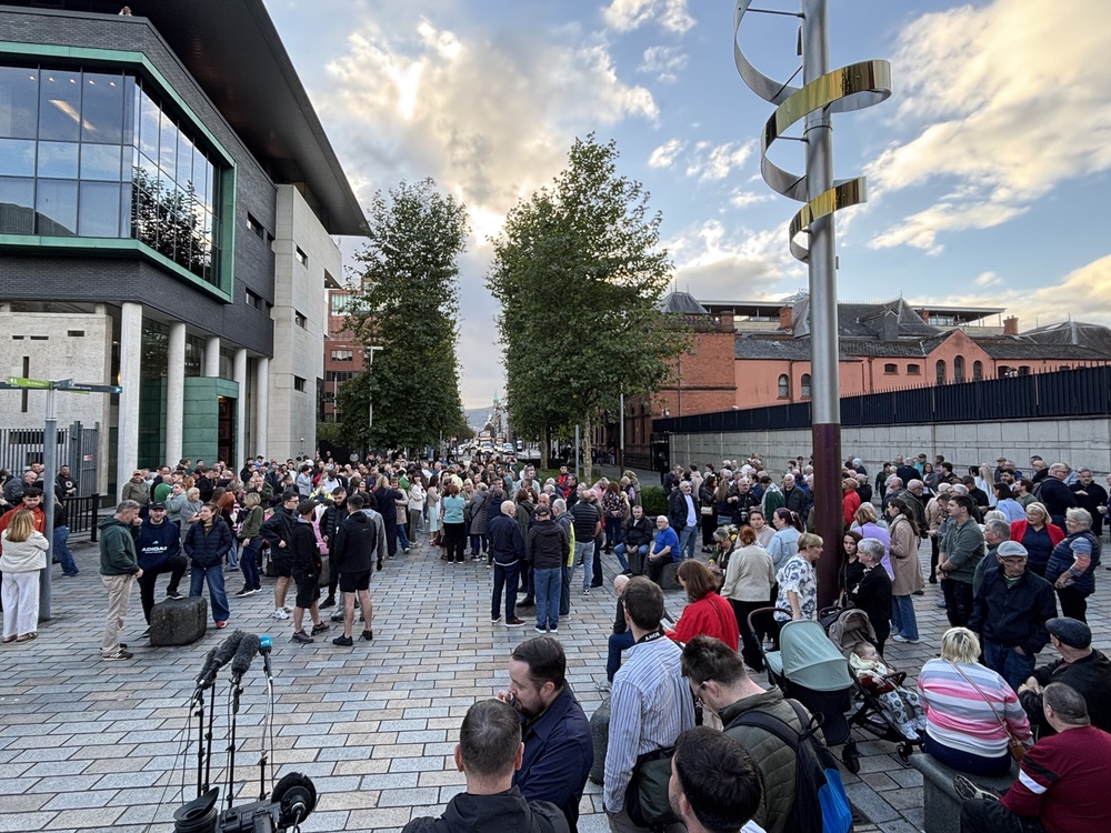 People gathered outside the Royal Courts of Justice in Belfast (Rebecca Black/PA) (PA Wire)