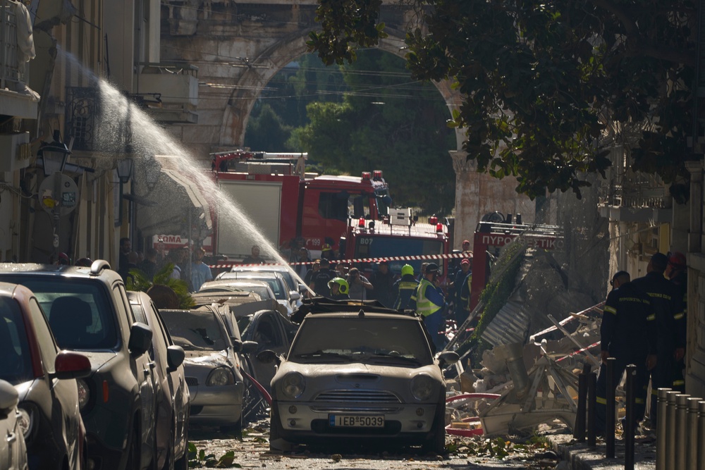 Firefighters work at the scene on the street leading to Hadrian’s Gate in central Athens (Petros Giannakouris/AP) (AP)