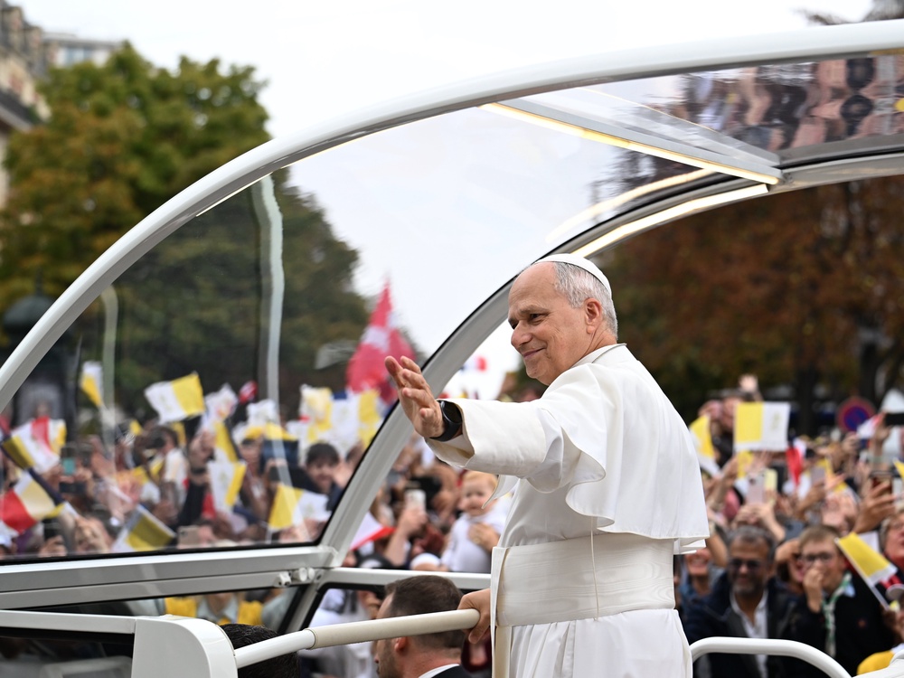 Pope Leo XIV waves to the crowd on the Champs-Élysées avenue (AP)