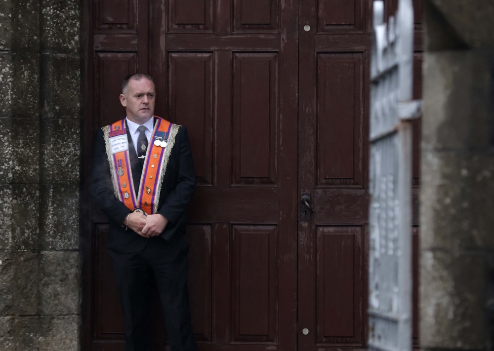 A member of the Orange Order outside Drumcree Parochial Hall in Portadown (PA Wire)