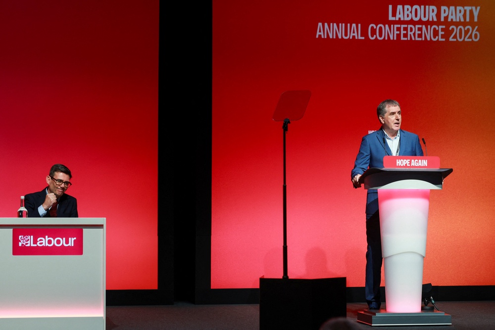 Andy Burnham gestures as mayor of the Liverpool City Region, Steve Rotheram, speaks during the Britain's Labour Party's annual conference (Reuters)