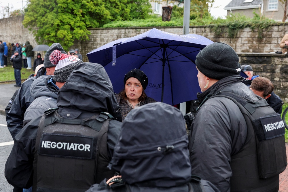 Deirdre Hargey, member of the Irish Sinn Fein party, speaks to the police negotiators (Reuters)