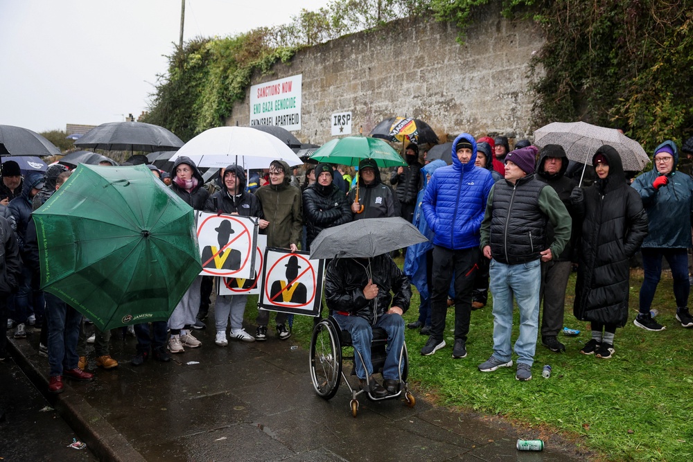 Protesters shelter from the rain as a standoff continues (Reuters)