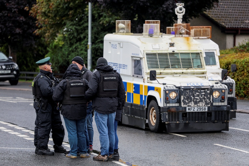 Police negotiators at the scene in Garvaghy Road (Reuters)
