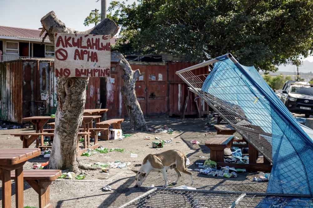 A dog walks among debris at an entertainment venue in Somerset West on September 27, 2026, after armed gunmen stormed the premises (AFP/Getty)