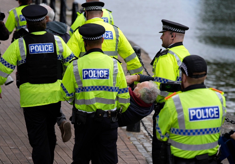 Police remove a demonstrator at a protest in support of Palestine Action at Labour conference (PA)