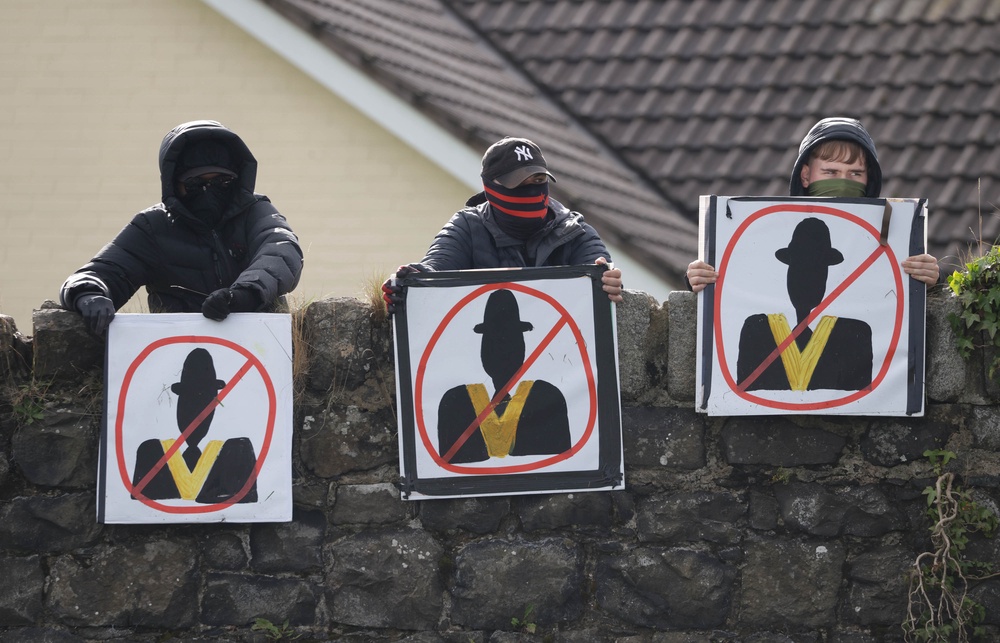 Protesters holding signs as the stand off continues (PA)