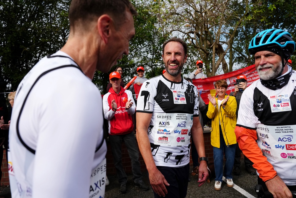 Sir Gareth Southgate (centre) also ran the final stage towards Shiptonthorpe Village Hall (Martin Rickett/PA) (PA Wire)