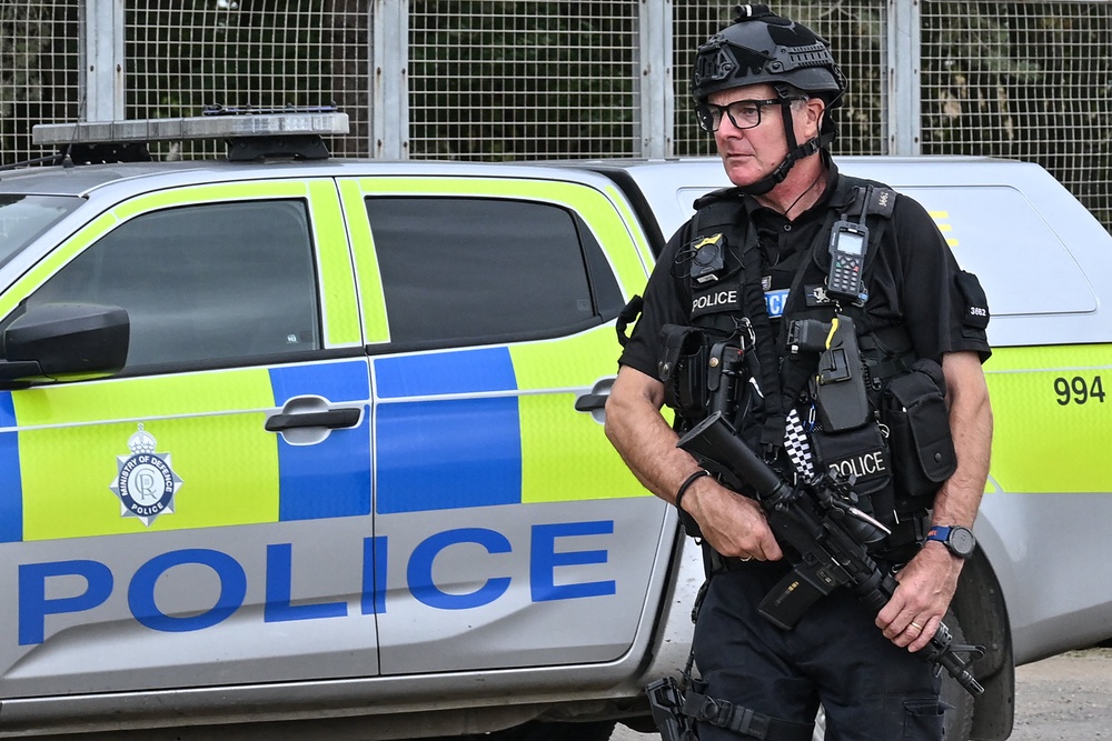An armed policeman mans a roadblock at an entrance to RAF Fairford base in Fairford, south-west England on September 27, 2026 (AFP/Getty)