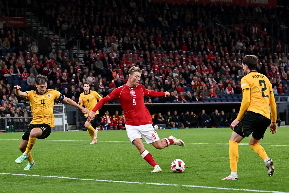 Rasmus Hojlund of Denmark shoots under pressure from Ben Davies of Wales (Getty)