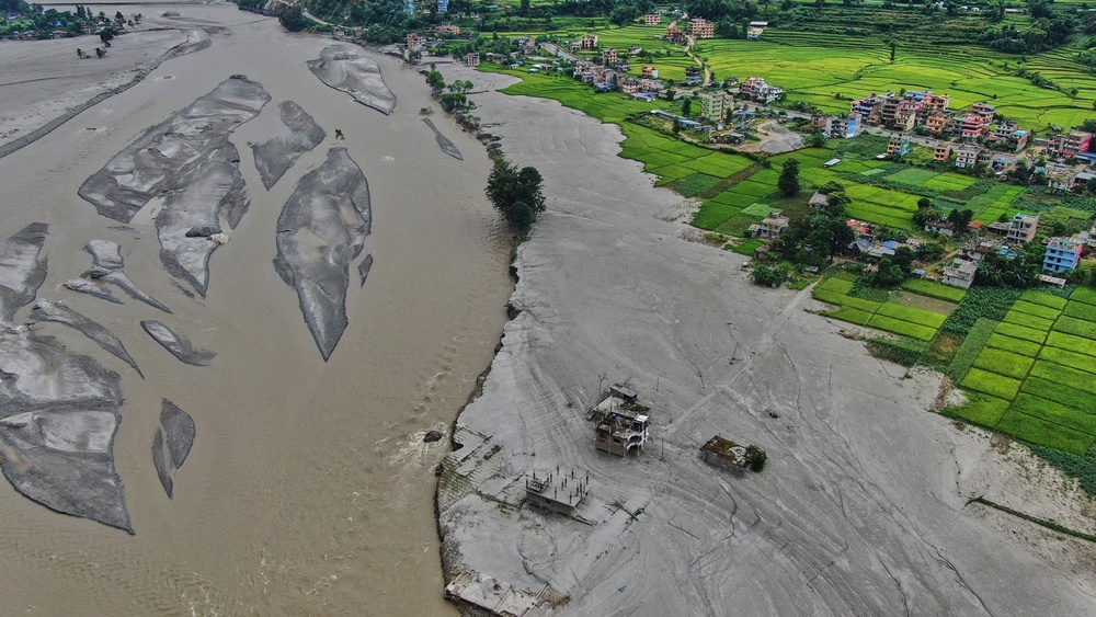 Farmland lies covered in mud after flash floods in Galchi in Nepal (AP)