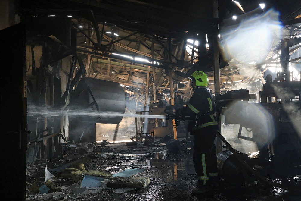 A firefighter works at the site of an enterprise hit by a Russian drone strike, amid Russia's attack on Ukraine, on the outskirts of Odesa (Reuters)