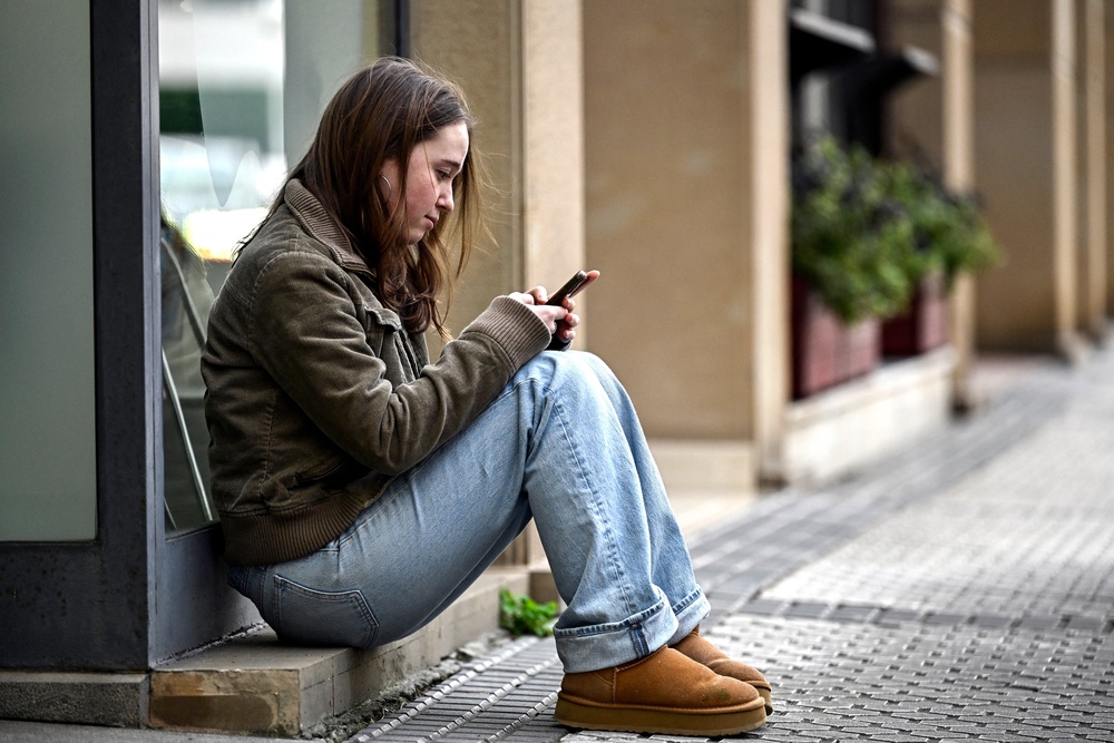 A girl uses her phone in the Spanish Basque city of San Sebastian in February. Experts stress that parents consider the health impacts of smartphones on their children (AFP via Getty Images)