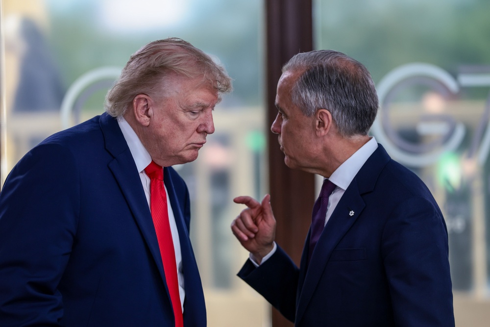 President Donald Trump speaks with Canadian Prime Minister Mark Carney at a working lunch with leaders of G7 and the Middle East, on June 16, 2026 (Getty Images)