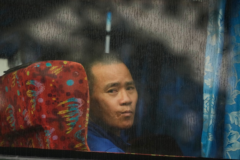 A Myanmarese national being deported looks out from a bus in Manjung, Perak state, Malaysia (AP)