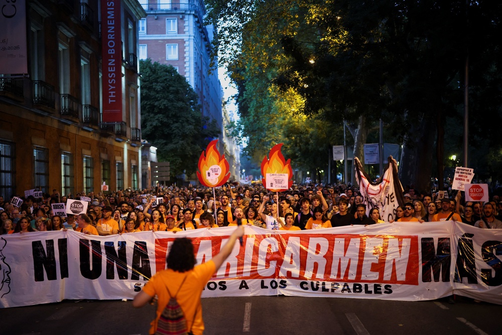 Demonstrators hold a banner reading: 