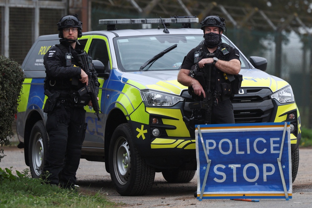 Police officers guard an area as roadblocks remain in place near RAF Fairford airbase (Reuters)