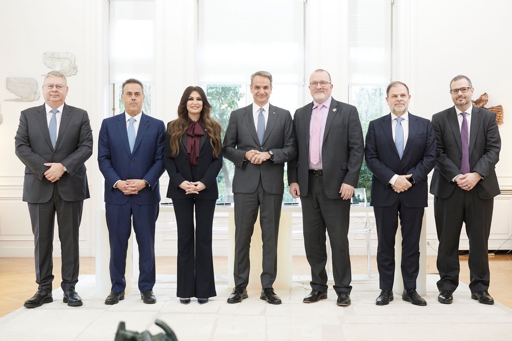 Guilfoyle with Greek politicians including energy minister Stavrous Papastravou (to Guilfoyle's left in the image) (PA)