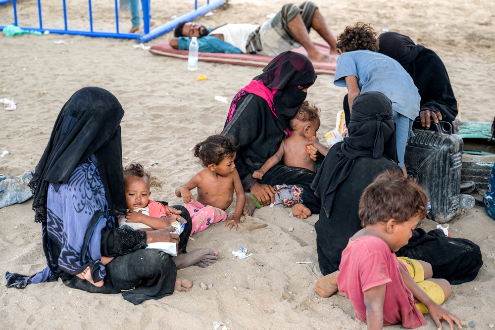 Displaced Yemeni women gather with their children in a displaced persons camp north of Aden earlier this month (AFP/Getty)