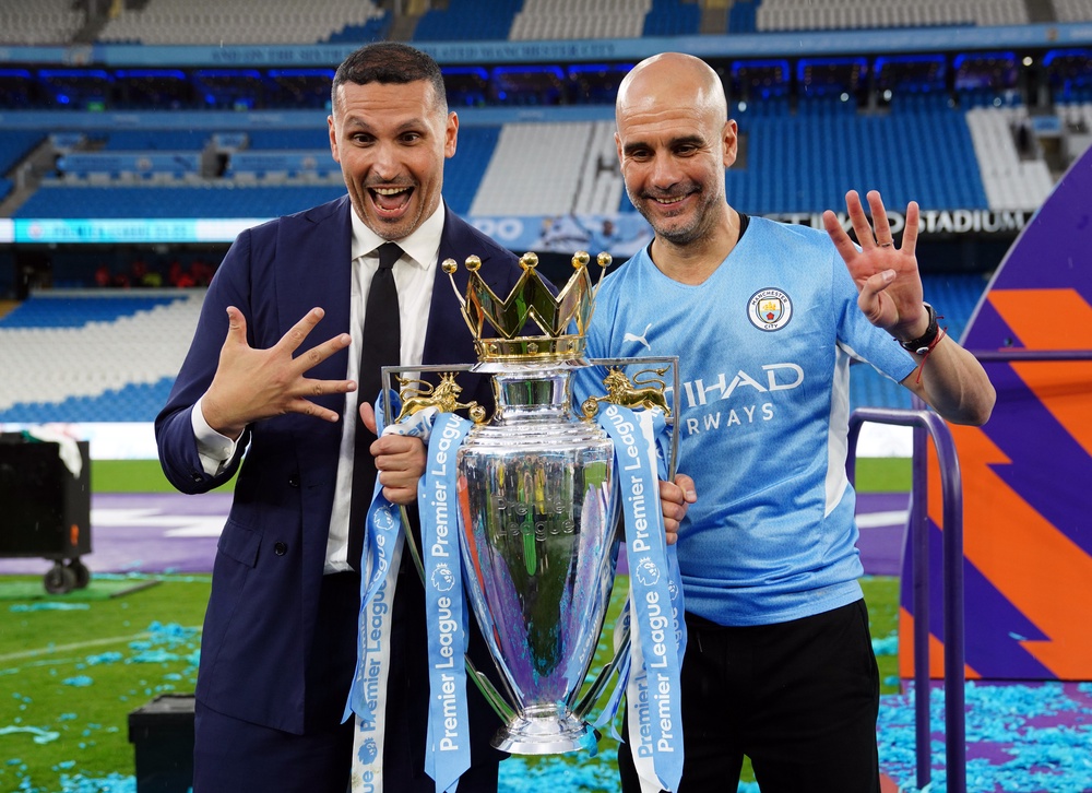Former Man City manager Pep Guardiola signals winning four Premier League titles in the last five seasons alongside chairman Khaldoon Al Mubarak (PA)