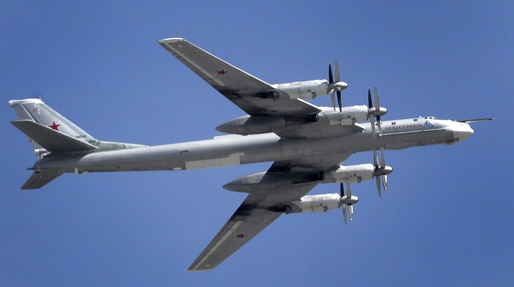 A Russian Tupolev Tu-95 turboprop-powered strategic bomber flies above the Kremlin in Moscow, on May 7, 2015 (AFP via Getty Images)