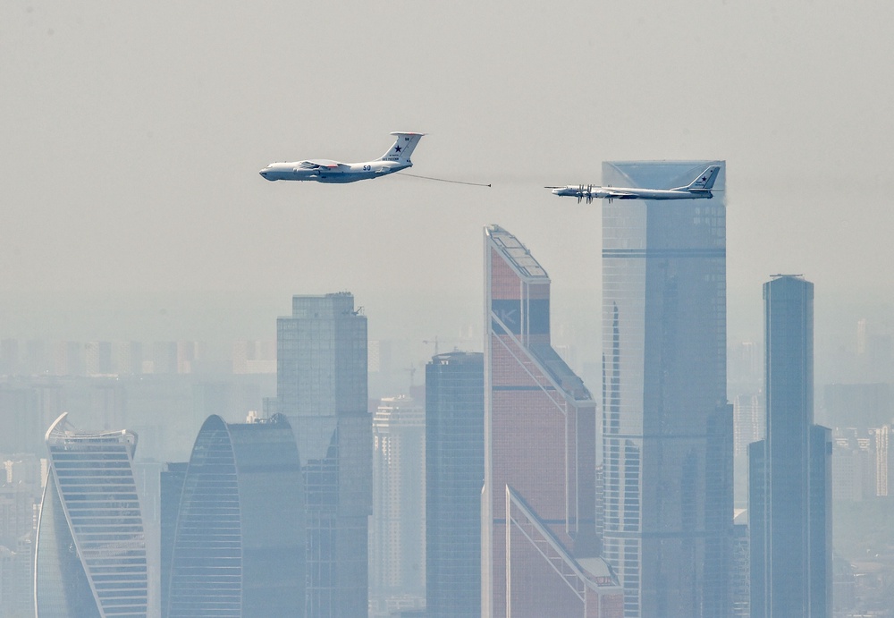 A Russian IL-78 tanker (right) approaches to refill a TU-95MS bomber flying over skyscrapers of the Moscow International Business Centre (Moskva City) on May 7, 2019 (AFP via Getty Images)