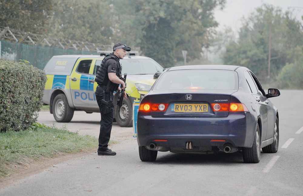 An armed police at a checkpoint near RAF Fairford in Gloucestershire (Ben Birchall/PA) (PA Wire)