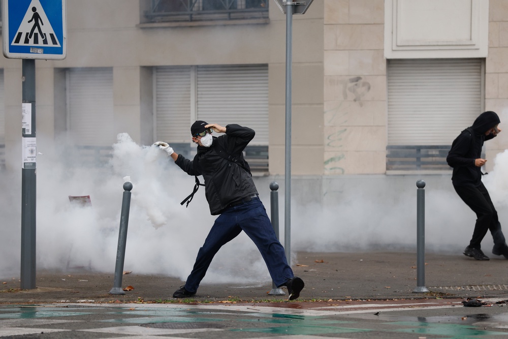 A high school student throws a tear gas canister as he protests to demand more resources for schools, in Lille, France, Wednesday, Sept. 30, 2026. (AP Photo/Jean-Francois Badias) (AP)