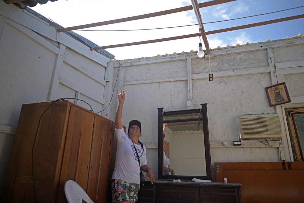 Resident Elvira Sanchez shows her house, which lost its roof, in the town of Puerto Adolfo Lopez Mateos, Baja California Sur state, Mexico. (AFP/Getty)