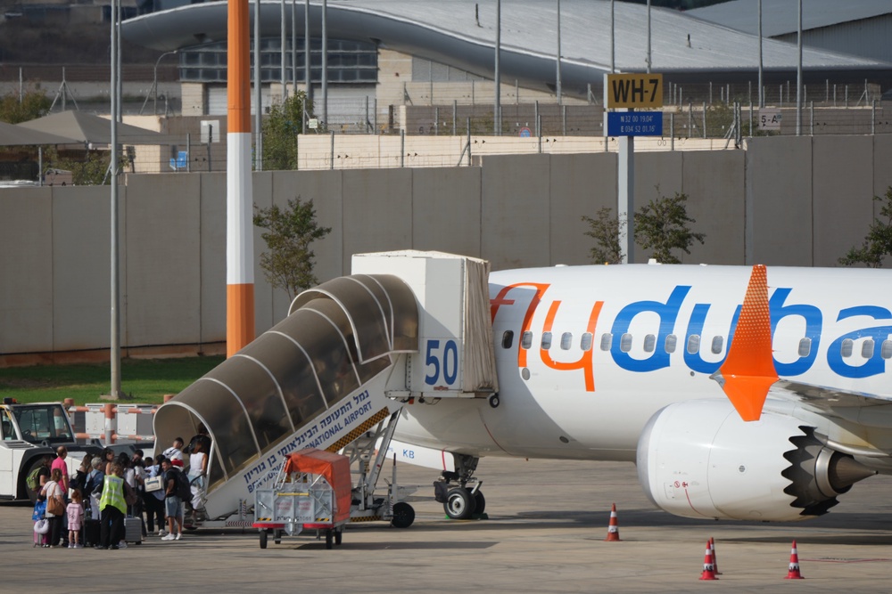 Passengers embark on a FlyDubai aircraft at Ben Gurion International Airport, near Tel Aviv (AP)