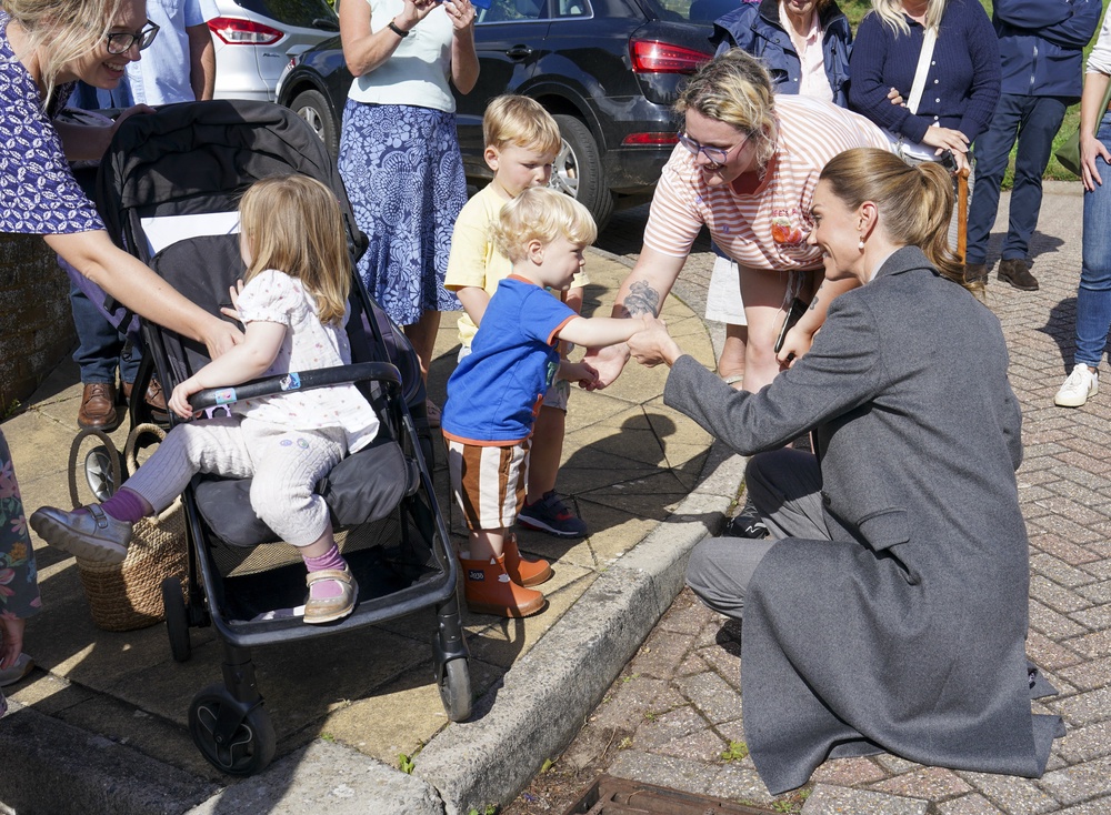 Kate helps one-year-old Albie Botley-Greenslade jump from a kerb in Pulborough, West Sussex (Arthur Edwards/The Sun/PA) (PA Wire)