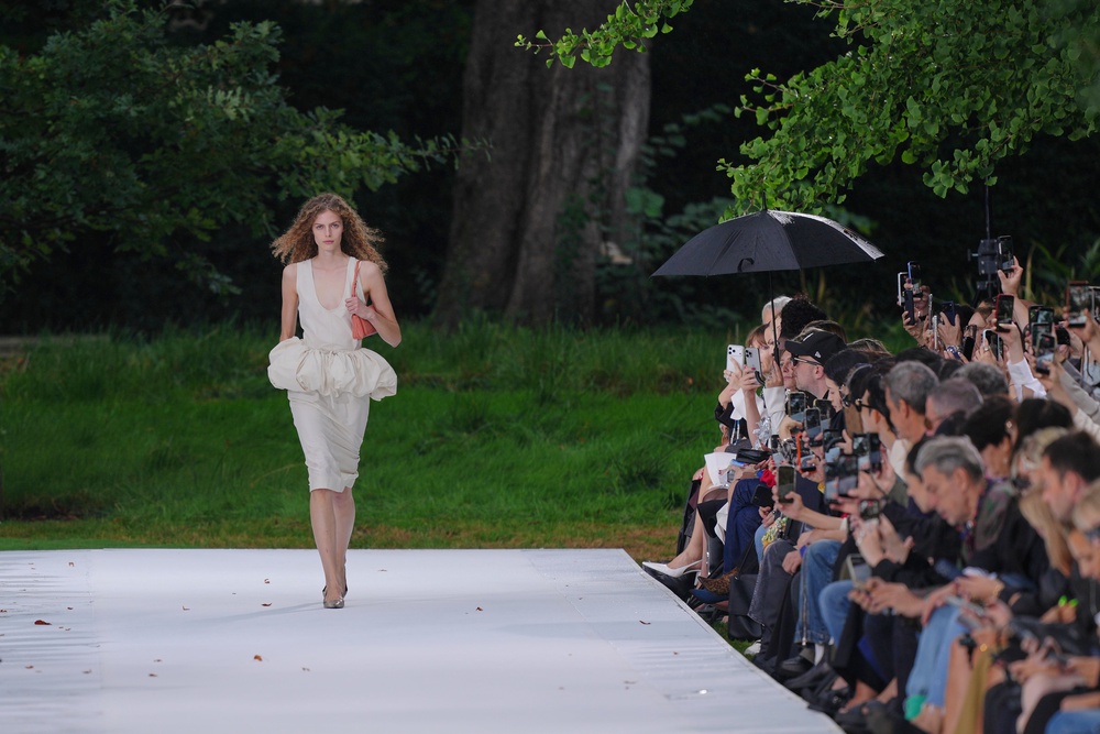 The opening look was a scoop-necked midi dress with a ruffled peplum (Aurelien Morissard/AP) (AP)