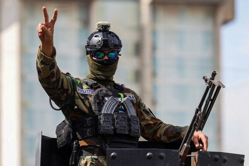 A member of the Iraqi security forces gestures after the last U.S. troops left an air base in northern Iraq under a deal between Baghdad and Washington (Reuters)