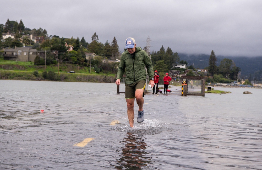 A jogger makes his way along a flooded Mill Valley bike path during a king tide event in January 2022. This year, the king tides are expected to be even worse than normal (AFP via Getty Images)
