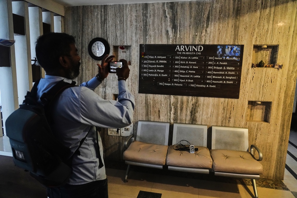 News media personnel film in the building where relatives of Smit Machchhar, an Indian pilot for Flydubai, previously lived in Mumbai, India, Thursday, Oct. 1, 2026. (AP Photo/Rafiq Maqbool) (Copyright 2026 The Associated Press. All rights reserved)
