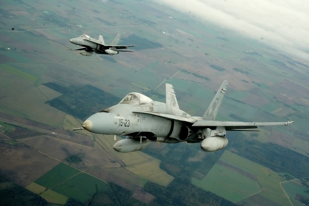 Spanish Air Force F-18 fighter jets fly over Lithuania during a Nato media tour on 30 September (Reuters)