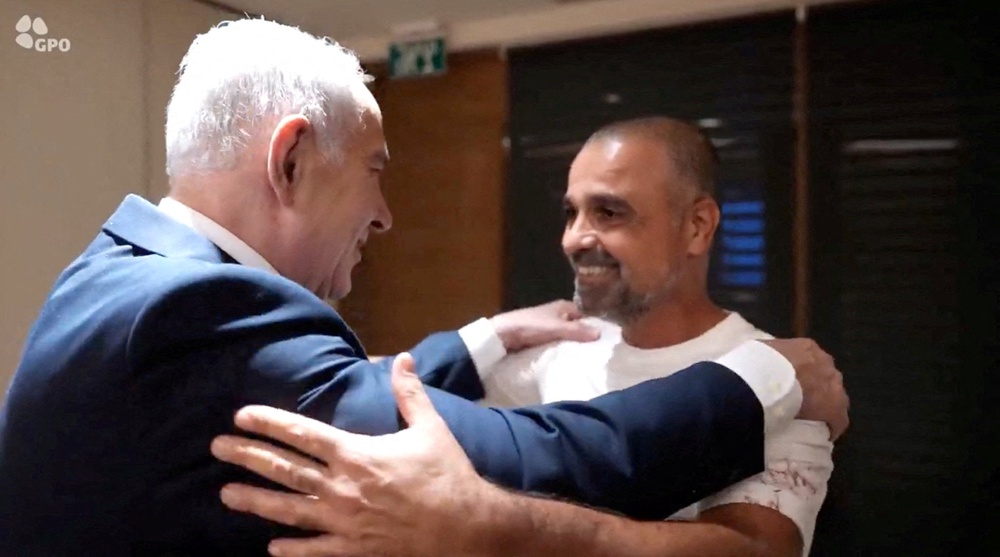 Israeli Prime Minister Benjamin Netanyahu meets Yaniv Hayun, a passenger on the FlyDubai flight bound for Israel from the United Arab Emirates (Reuters)