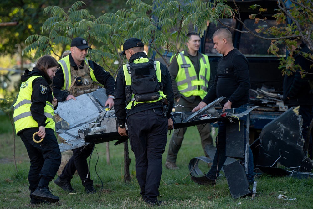Ukrainian police officers collect debris of a Russian drone that crashed near a children's playground among residential buildings and did not detonate, in Kyiv on 30 September 2026, amid the Russian invasion of Ukraine (AFP/Getty)