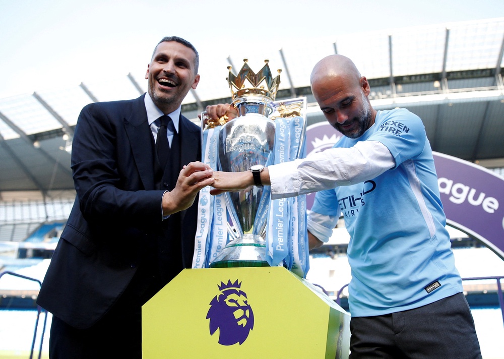 Khaldoon Al Mubarak, left, pictured with manager Pep Guardiola after winning the 2017/18 Premier League title (Reuters)