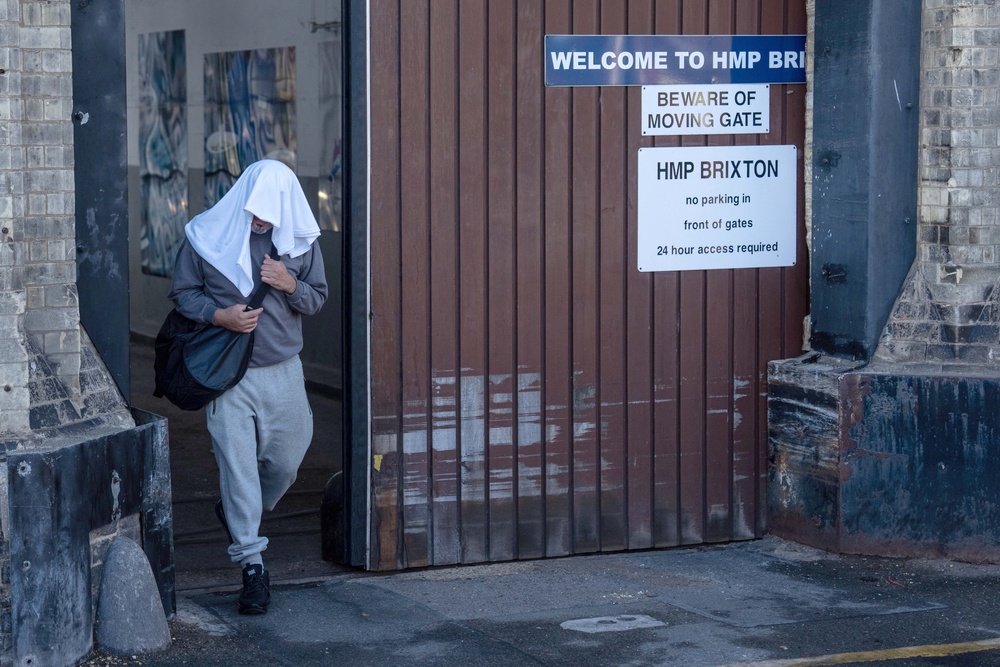 An inmate walks from HMP Brixton on early release (Getty)