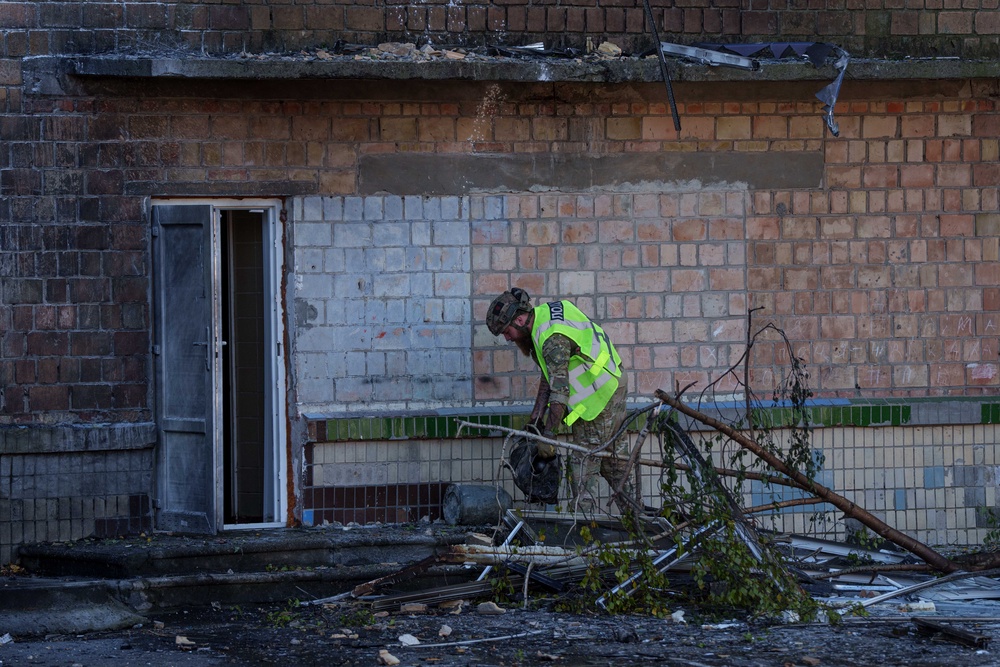 A police officer carries the engine of a Shahed drone out of a school damaged by a Russian strike in Kyiv, Ukraine, Thursday, 1 Oct 2026 (AP)