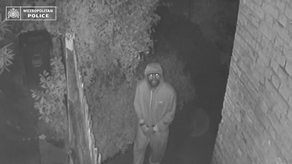 Ashley Malcolm outside the home of John Burke on the night of the burglary (Metropolitan Police)