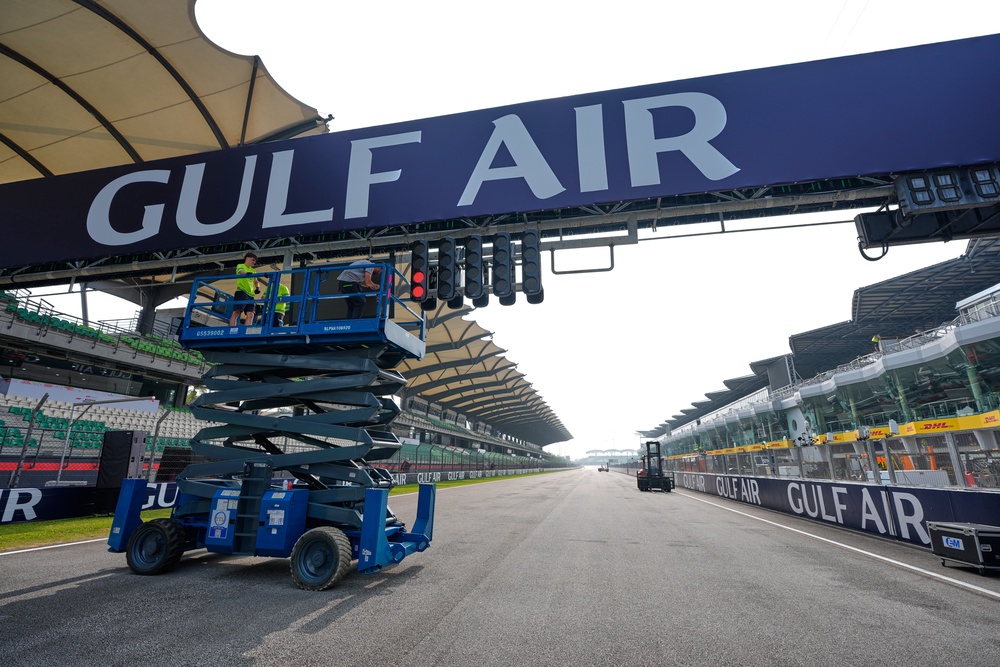 A Gulf Air banner is installed above the starting grid at the Sepang circuit (AP)