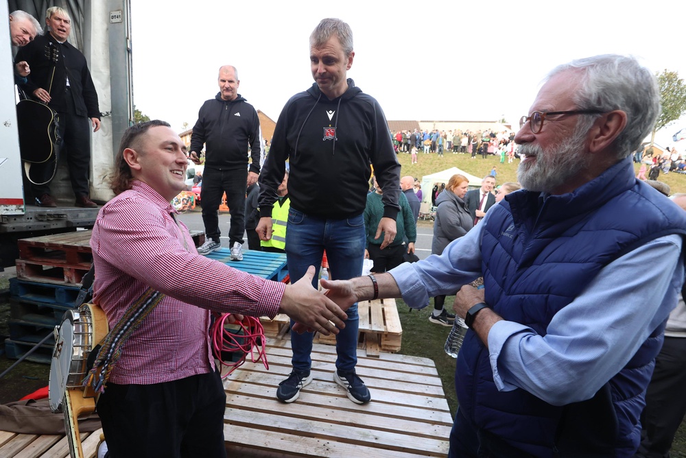 Former Sinn Féin president Gerry Adams (left) talks to The Mary Wallopers after they performed on Garvaghy Road, Portadown (Liam McBurney/PA) (PA Wire)